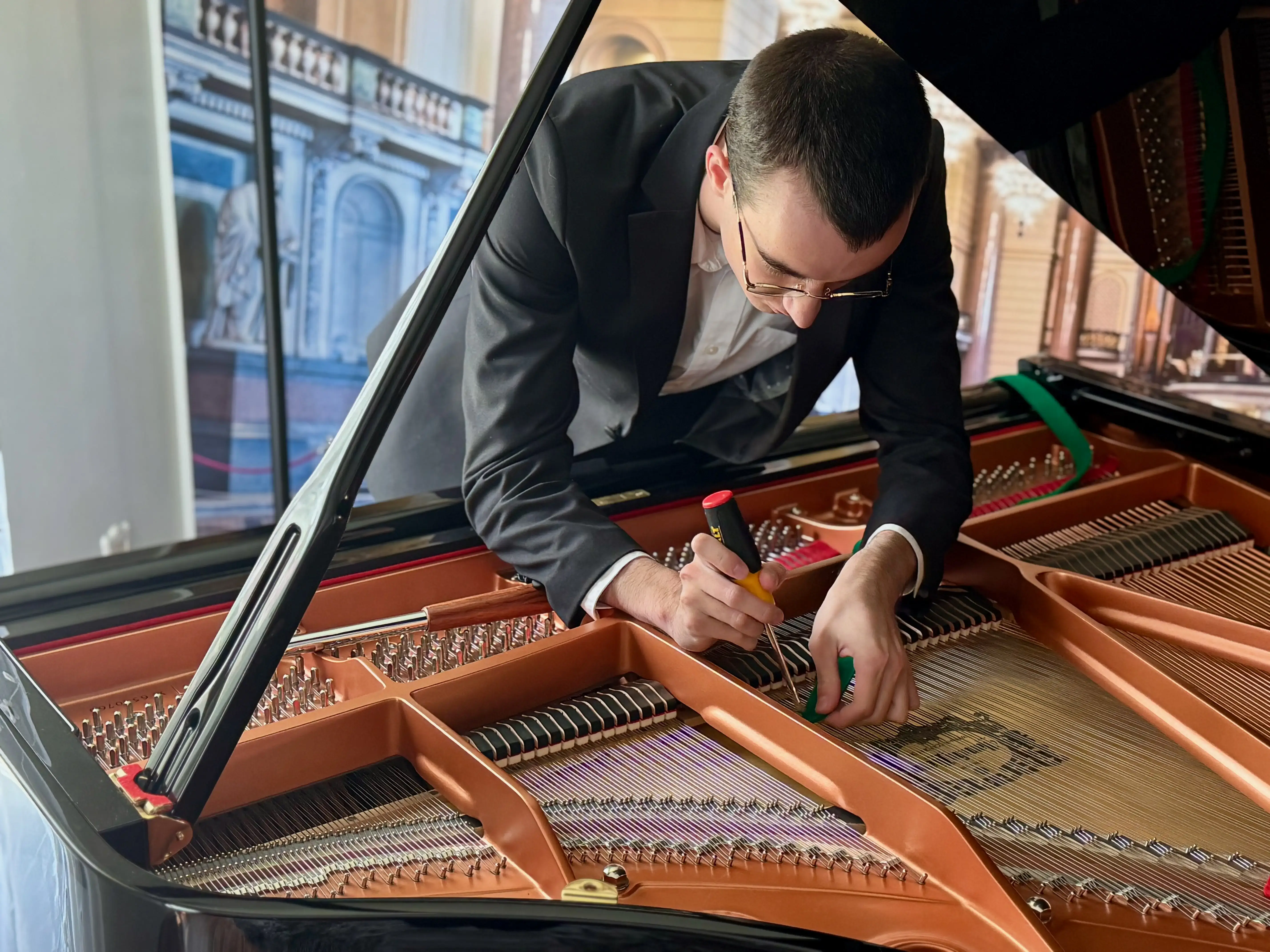 Chris Fler tuning a piano